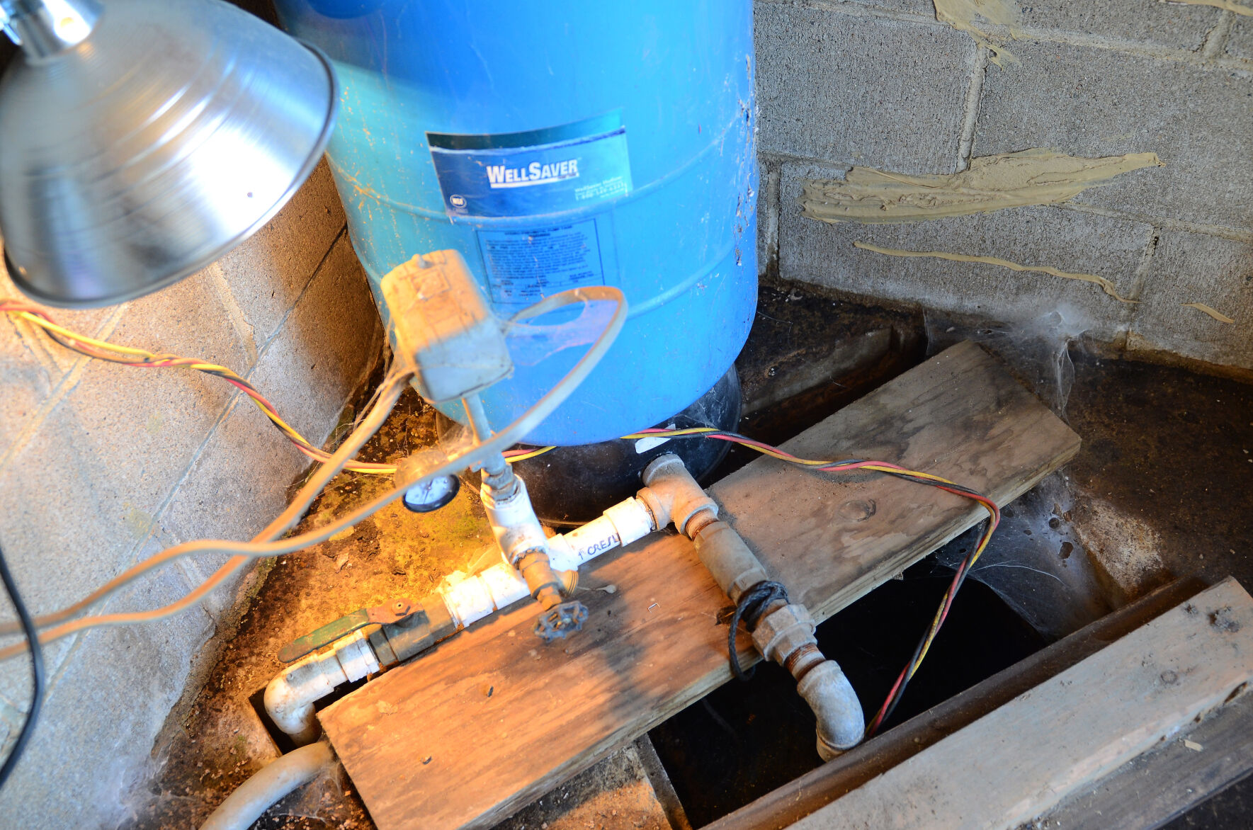 Two groundwater pumps sit behind Doug Doughty's home